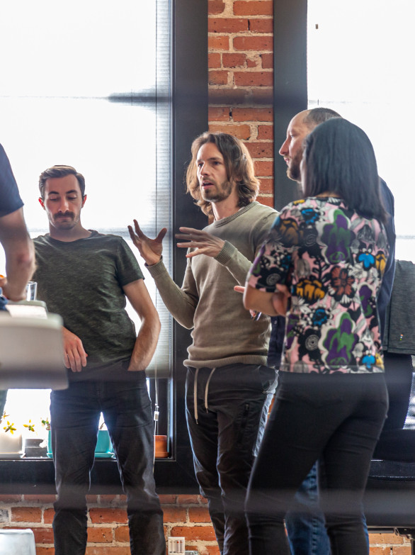 By the Pixel team members standing and talking